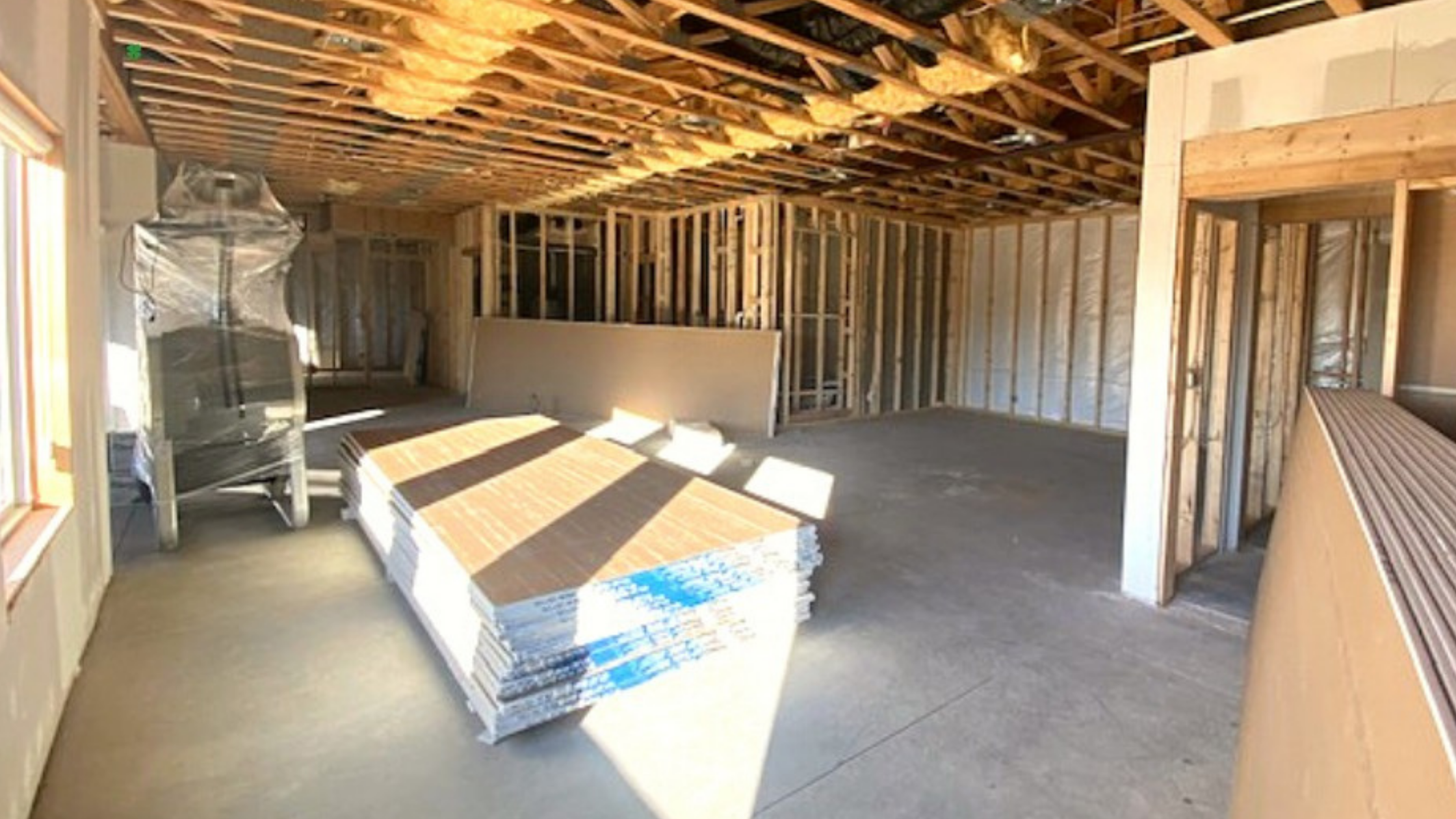 a unfinished basement being framed in with wood