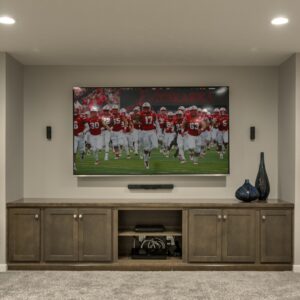 an empty basement with a tv on the wall