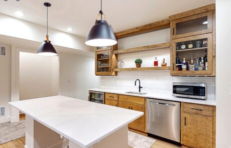 A basement kitchen with wood cabinets designed by hawthorne basements