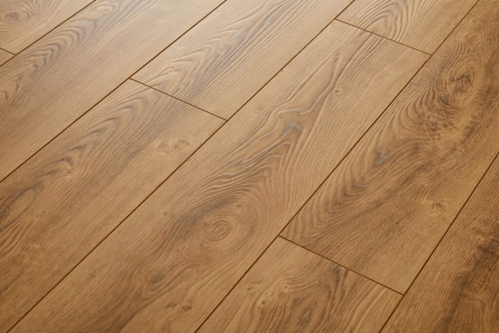 Close-up of luxury vinyl plank basement flooring with natural wood grain texture and waterproof finish