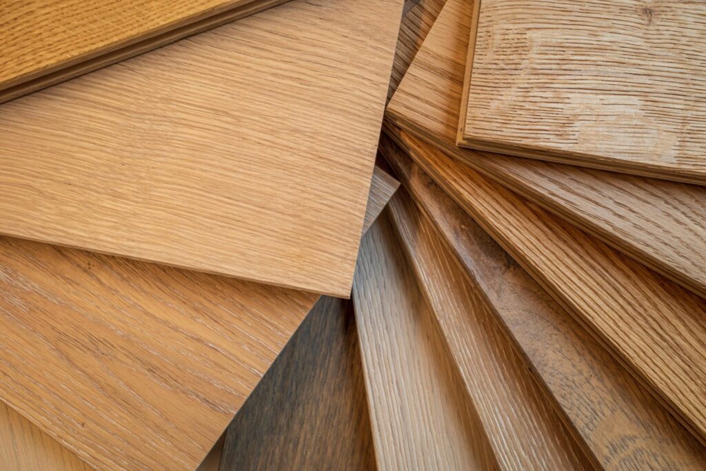 Collection of waterproof basement flooring samples including wood, laminate, and luxury vinyl planks